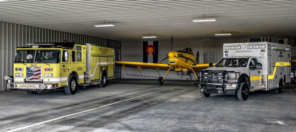 A fire truck, ambulance, and small airplane in our station