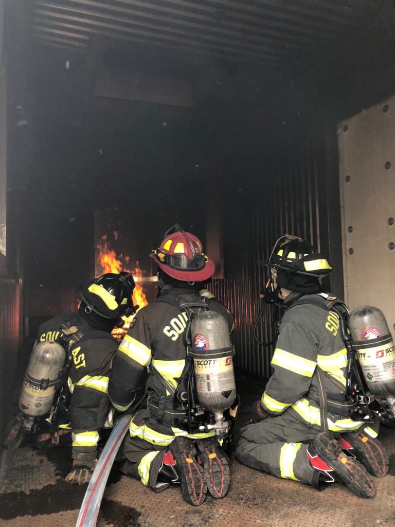 Working to put out a fire in a commercial building